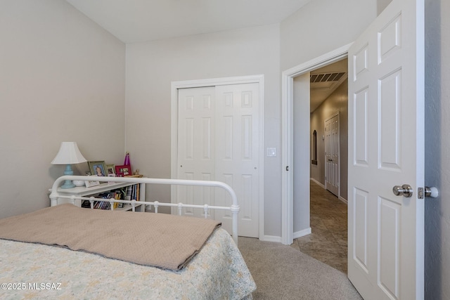 bedroom featuring baseboards, carpet, a closet, and visible vents