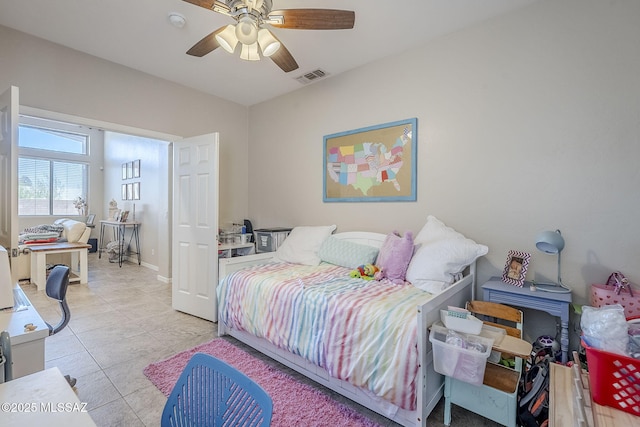bedroom featuring baseboards, a ceiling fan, light tile patterned flooring, and visible vents