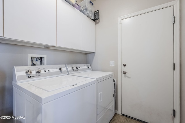 laundry area with washing machine and clothes dryer and cabinet space