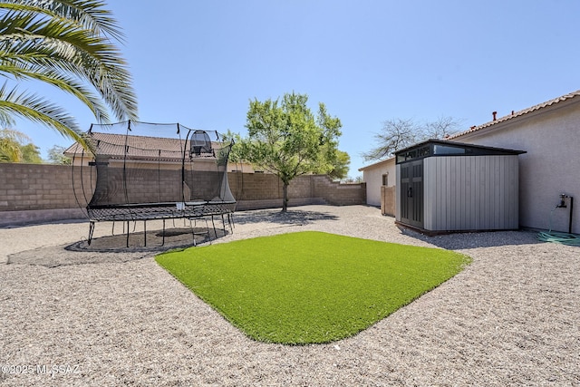 view of yard featuring a patio, a fenced backyard, and a trampoline