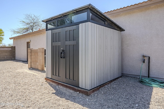 view of shed with fence