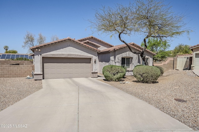 view of front of home featuring fence, stucco siding, concrete driveway, an attached garage, and a tile roof