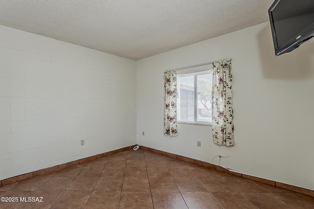 221 N Calle Del Lago, Green Valley, AZ 85614 - empty room with tile patterned floors, baseboards, and a textured ceiling