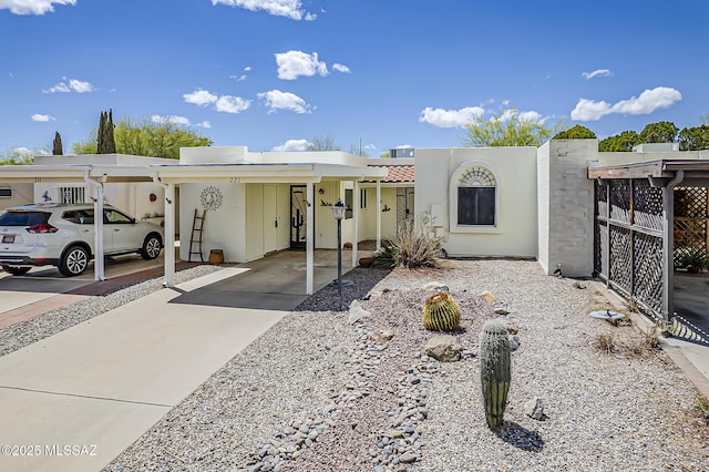 221 N Calle Del Lago, Green Valley, AZ 85614 - view of front of house featuring driveway, stucco siding, and an attached carport