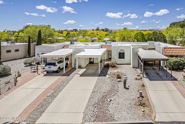 221 N Calle Del Lago, Green Valley, AZ 85614 - view of front of house with a carport, driveway, and stucco siding