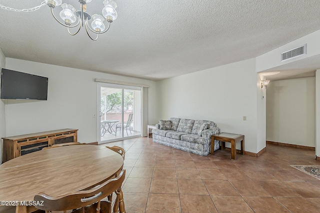 221 N Calle Del Lago, Green Valley, AZ 85614 - tiled living area featuring a textured ceiling, an inviting chandelier, baseboards, and visible vents