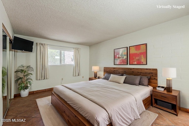 221 N Calle Del Lago, Green Valley, AZ 85614 - bedroom featuring a textured ceiling and light tile patterned floors