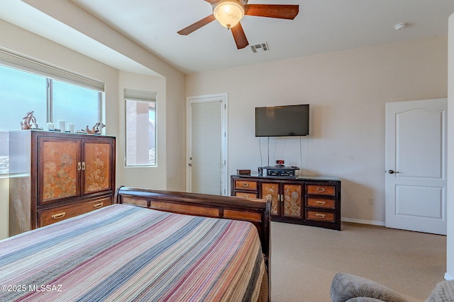 bedroom with carpet floors, baseboards, ceiling fan, and visible vents