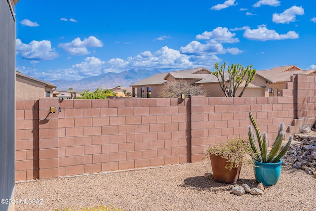 view of yard with a mountain view and a fenced backyard