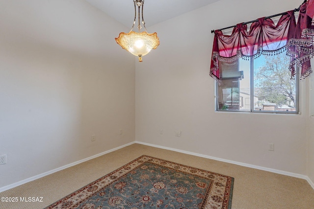 unfurnished room featuring carpet flooring and baseboards