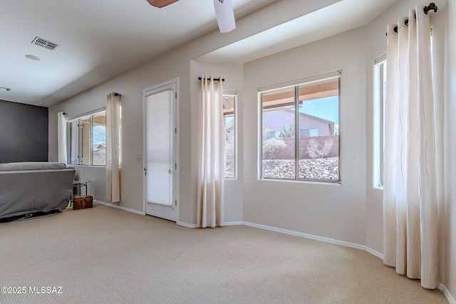unfurnished bedroom featuring carpet, visible vents, and baseboards