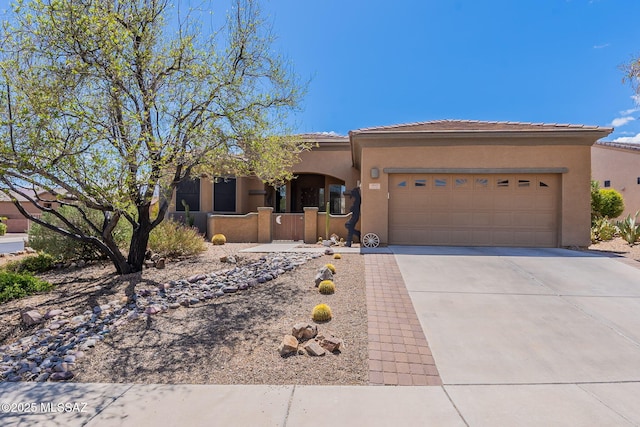 view of front of property with a fenced front yard, a garage, stucco siding, a tile roof, and driveway