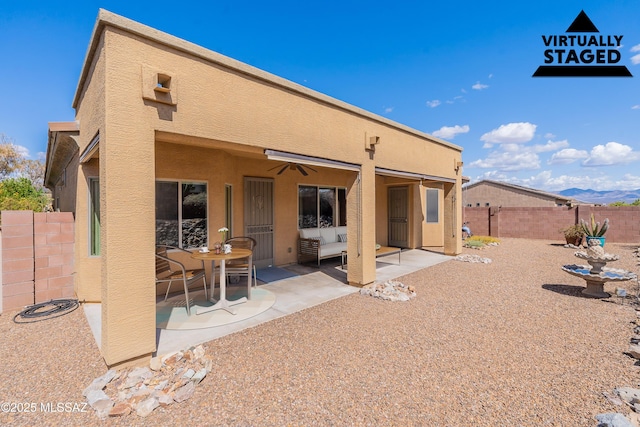 back of house featuring a patio, stucco siding, a fenced backyard, and ceiling fan