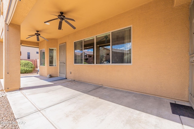 view of patio / terrace featuring ceiling fan and fence