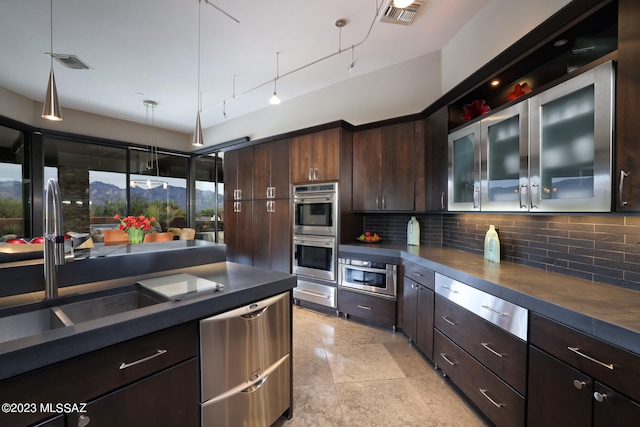 kitchen featuring visible vents, decorative backsplash, appliances with stainless steel finishes, and dark brown cabinets