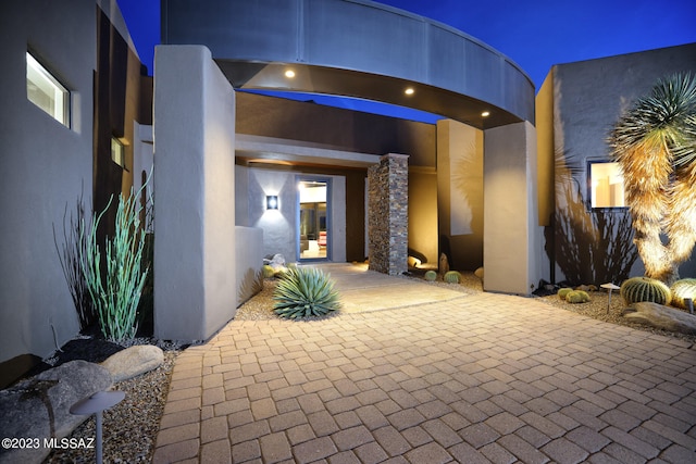 exterior entry at twilight with stucco siding