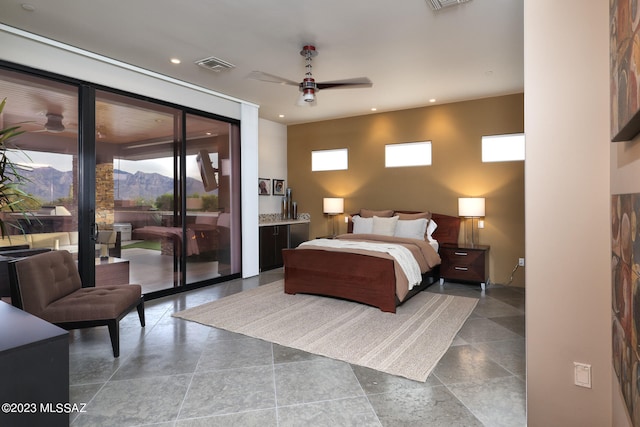 bedroom with recessed lighting, visible vents, access to exterior, and a mountain view