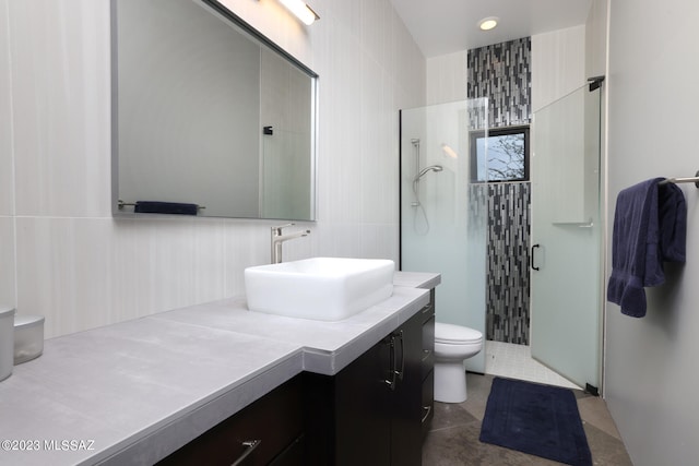 full bath featuring vanity, decorative backsplash, toilet, tile walls, and a stall shower