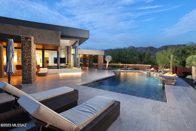 view of swimming pool featuring a fenced in pool, a patio area, and an outdoor fire pit