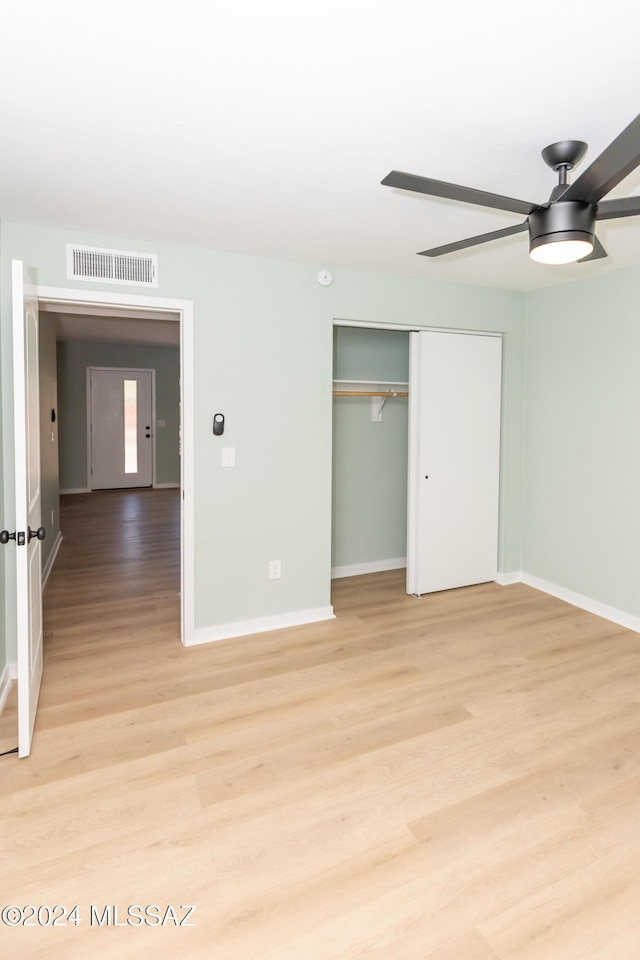 3030 N 2nd Ave, Tucson, AZ 85705 - unfurnished bedroom featuring visible vents, light wood-style flooring, a closet, and baseboards
