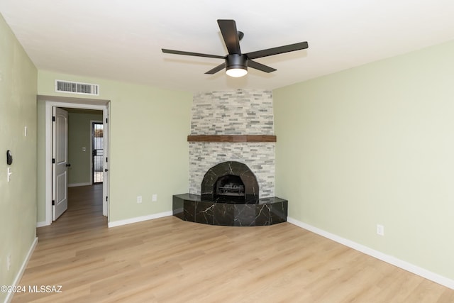 3030 N 2nd Ave, Tucson, AZ 85705 - unfurnished living room featuring a tiled fireplace, visible vents, ceiling fan, and wood finished floors