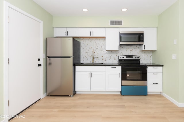 3030 N 2nd Ave, Tucson, AZ 85705 - kitchen featuring a sink, light wood-type flooring, dark countertops, white cabinetry, and stainless steel appliances