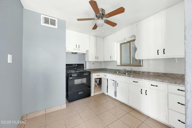 kitchen featuring visible vents, a sink, ceiling fan, under cabinet range hood, and black range with gas stovetop