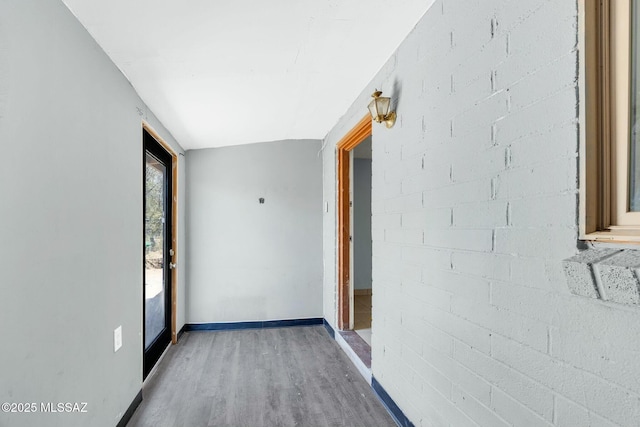 interior space with baseboards and wood finished floors