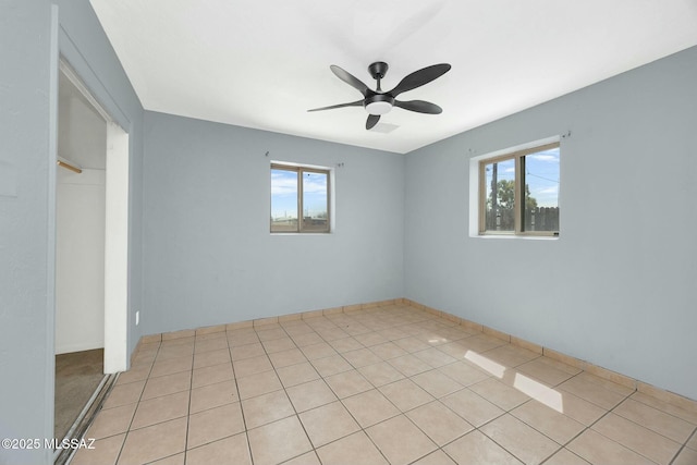 spare room with a healthy amount of sunlight and ceiling fan