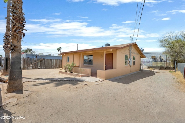 view of front of property featuring fence