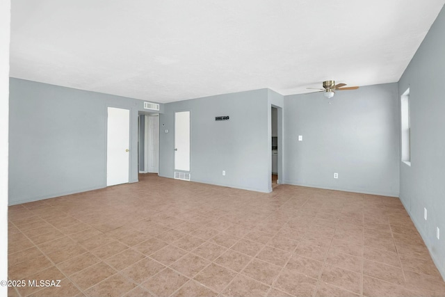 spare room featuring visible vents, baseboards, and a ceiling fan