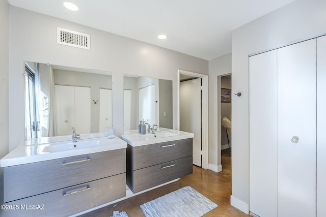 6120 E 5th St Unit B121, Tucson, AZ 85711 - full bath featuring two vanities, finished concrete floors, recessed lighting, and baseboards