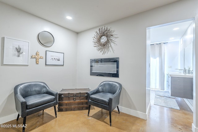 6120 E 5th St Unit B121, Tucson, AZ 85711 - living area featuring baseboards, concrete floors, and recessed lighting