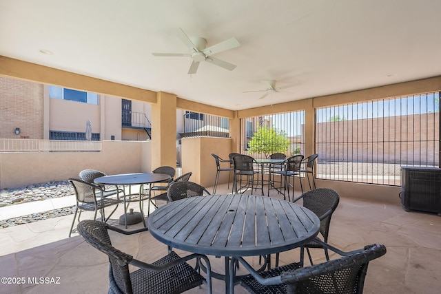 6120 E 5th St Unit B121, Tucson, AZ 85711 - view of patio featuring outdoor dining space, ceiling fan, and fence