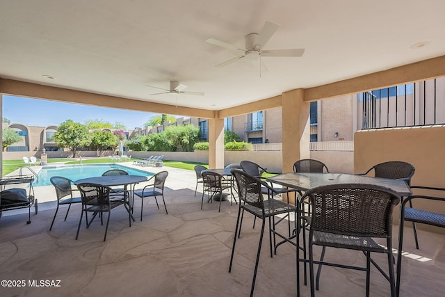 6120 E 5th St Unit B121, Tucson, AZ 85711 - view of patio featuring outdoor dining space, fence, and ceiling fan