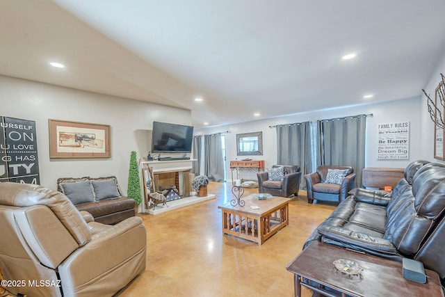 6120 E 5th St Unit B121, Tucson, AZ 85711 - living area with finished concrete floors, recessed lighting, and a fireplace with raised hearth
