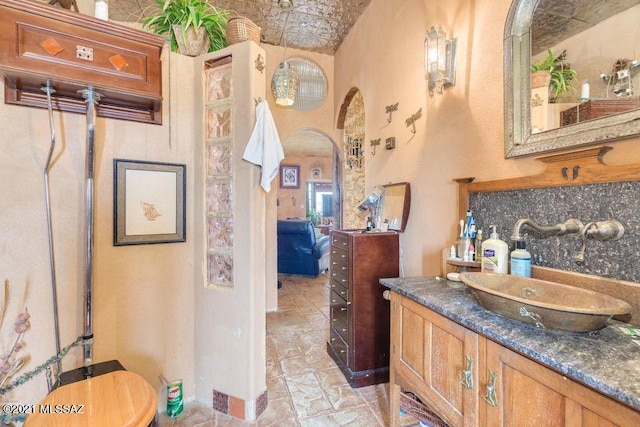 bathroom featuring an ornate ceiling and vanity
