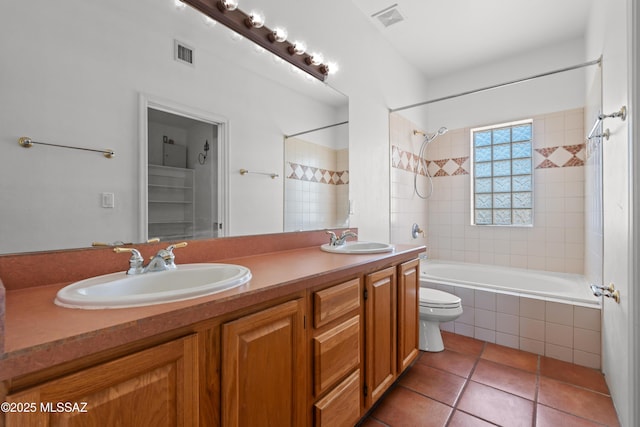 bathroom with visible vents, a sink, and tiled shower / bath combo
