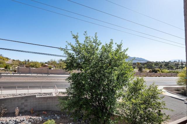 exterior space featuring a mountain view and fence