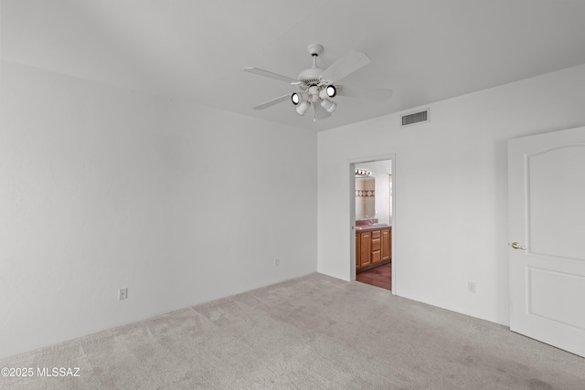 unfurnished room with ceiling fan, visible vents, and carpet floors