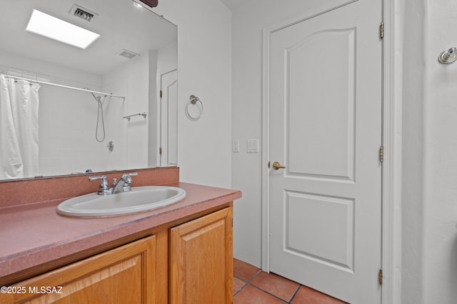 full bathroom with a shower with shower curtain, tile patterned flooring, vanity, and visible vents