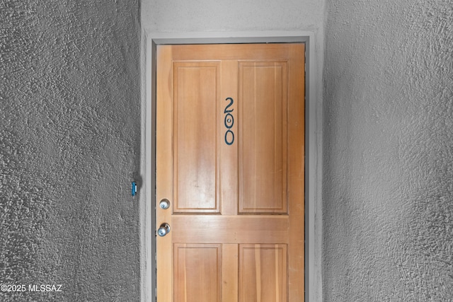 property entrance with stucco siding