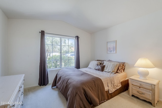 14180 N Trade Winds Way, Oro Valley, AZ 85755 - bedroom with light colored carpet, vaulted ceiling, and baseboards