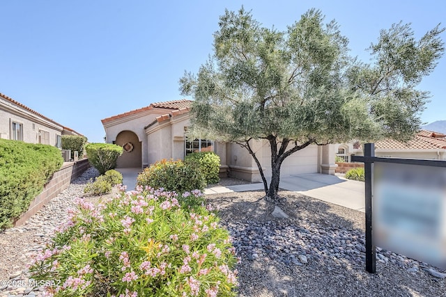 14180 N Trade Winds Way, Oro Valley, AZ 85755 - mediterranean / spanish home featuring driveway, stucco siding, a tiled roof, and an attached garage