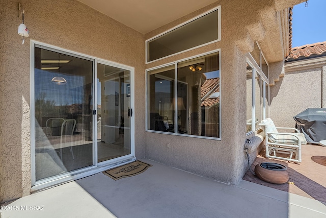 14180 N Trade Winds Way, Oro Valley, AZ 85755 - property entrance with stucco siding and a patio area