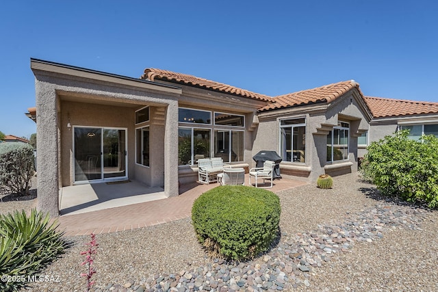 14180 N Trade Winds Way, Oro Valley, AZ 85755 - back of property featuring stucco siding, a patio, and a tile roof