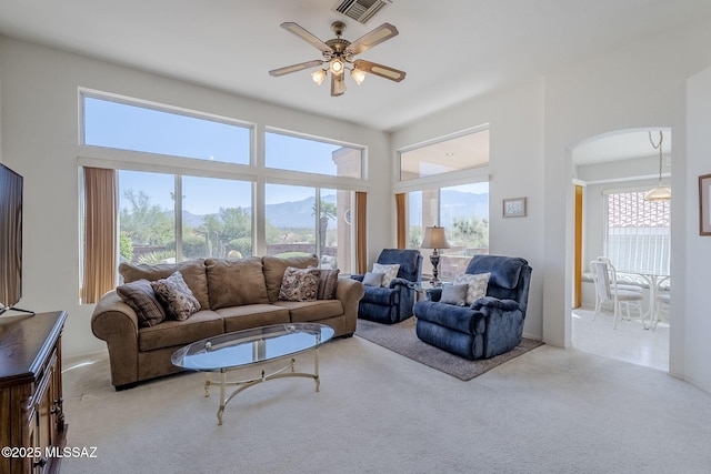 14180 N Trade Winds Way, Oro Valley, AZ 85755 - living area featuring carpet flooring, arched walkways, and a ceiling fan
