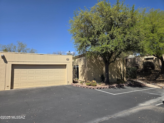 view of front of house with a garage and stucco siding