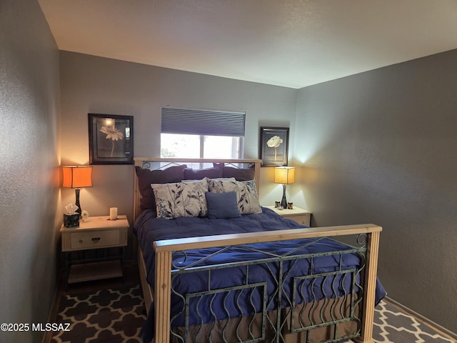 bedroom with a textured wall and carpet