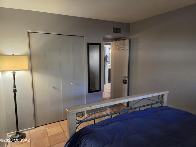 bedroom with visible vents and tile patterned flooring